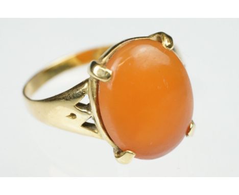 Carnelian unmarked yellow gold ring, the oval cabochon cut carnelian measuring approx 13 x 10.5mm, claw set, tapered shoulder