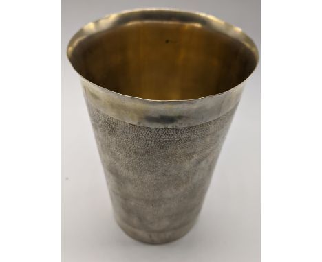 A Continental silver beaker with snakeskin pattern and integrated Austrian Maria Theresa coin, marked to base, 328g, H.15cm