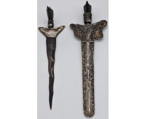 Two Eastern daggers, one with silver blade and  filigree silver scabbard, hallmarked, the other with horn blade, horns finial