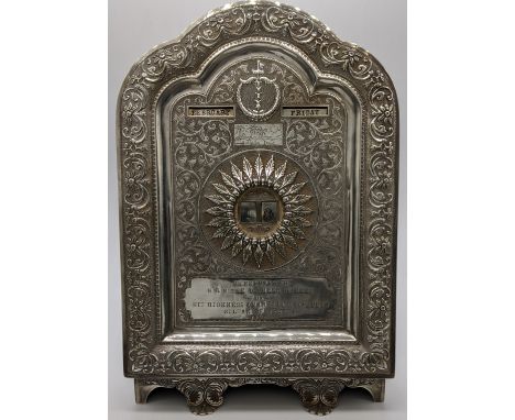 An Indian silver desk calendar, month, day and date rotating aperture, the lower cartouche reading Presented to H.R.H. The Du