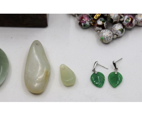 Two mutton fat jade pendants, green jade earrings, a jadeite circular pendant, cloisonne enamel bead necklace and a papier ma