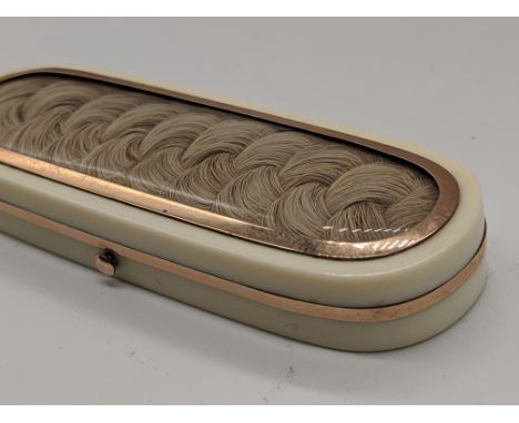 A 19th century ivory patch box/ toothpick case, mounted with gold and plaited hair, internal original mirror lined with velve