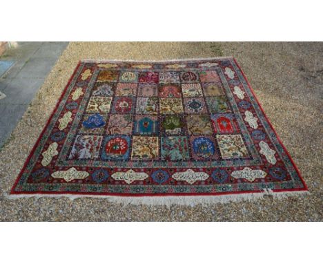 A North West Persian Woollen Carpet With Pictorial Panels within a border with panelled script, 350cm by 325cm 