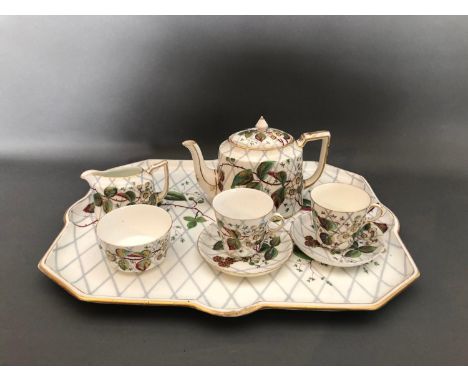 An Edwardian tea service, comprising two tea cups and saucers, teapot, cream jug, sugar bowl and tray, all decorated with ras