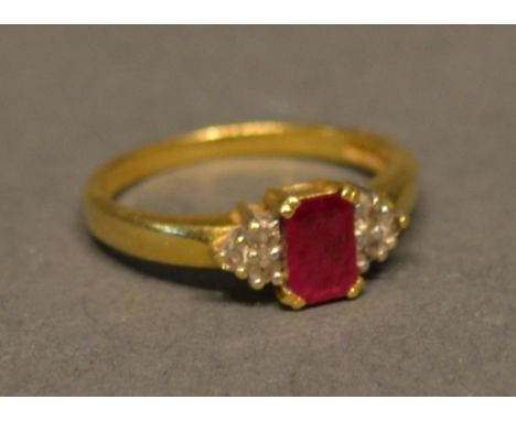 An 18ct. Yellow Gold, Ruby And Diamond Ring With A Central Rectangular Ruby flanked by diamonds&nbsp;