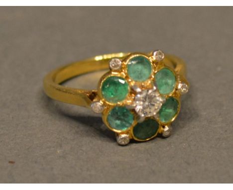 An 18ct. Gold, Emerald And Diamond Cluster Ring 