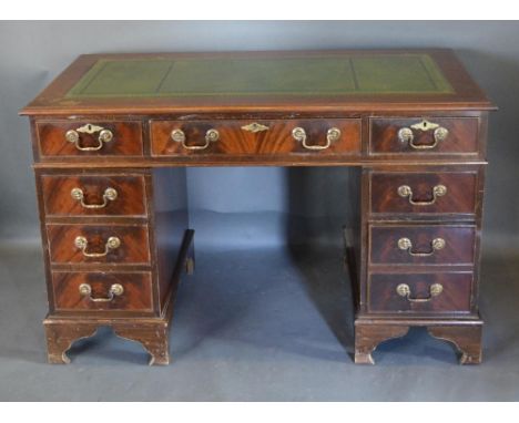 A Reproduction Mahogany Twin Pedestal Desk, The Green Tooled Leather inset top above nine drawers with brass handles, raised 