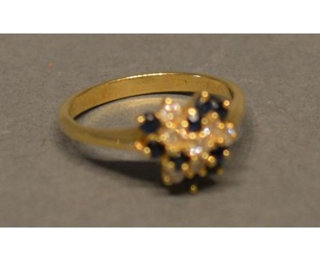 An 18ct. Yellow Gold Sapphire And Diamond Cluster Ring 