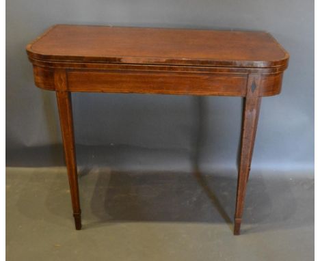 A 19th Century Mahogany Card Table, The Hinged Top enclosing a beige lined interior above a plain frieze, raised upon square 