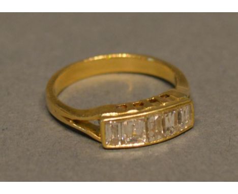 A Yellow Metal Diamond Band Ring Set With Five Baguette Cut Diamonds 