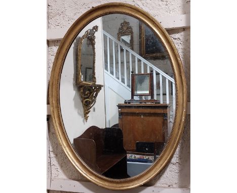 A 19th Century large giltwood oval Mirror, with beaded edge and moulded side, approx. 112cms x 84cms (44" x 33"). (1)