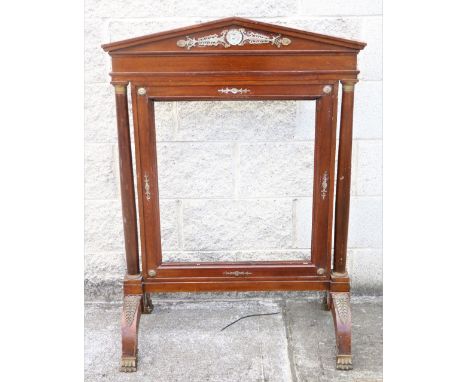 A Regency brass mounted Empire style Firescreen, the arched top over open centre flanked by pillars with ormolu mounts, on ou
