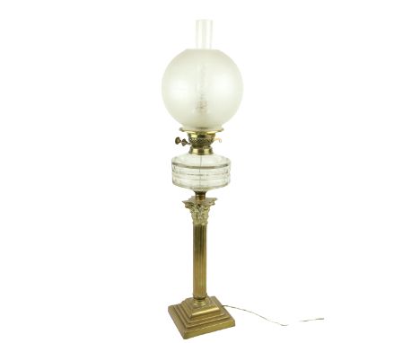 A brass Oil Lamp, late 19th Century, with reeded stem and Corinthian capital on square stepped base supporting a glass reserv