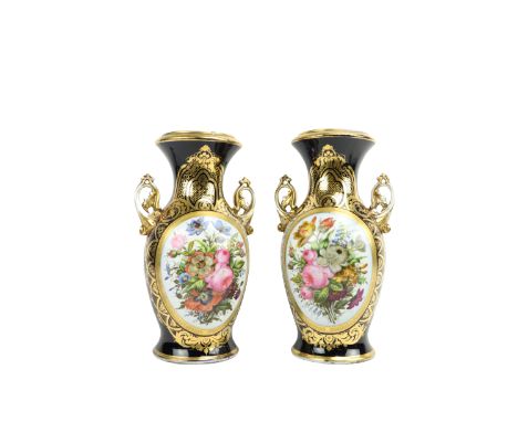 An attractive pair of 19th Century French dark blue and parcel gilt porcelain Vases, each with two handles and decorated with