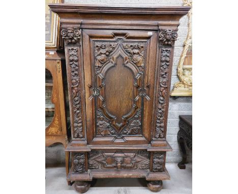 A 17th Century style carved oak Court Cupboard, with moulded cornice above a central door carved with figures representing th