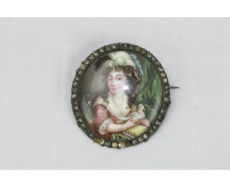 18th Century French Enamel  Miniature: A fine small circular Brooch, with painted scene of 'Young girl seated holding a dove,