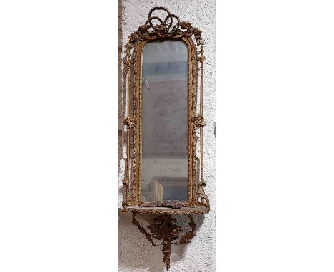 A 19th Century gilt Pier Mirror, with arched top crested with a ribbon bow and flower head on a ribbon moulded frame above a 