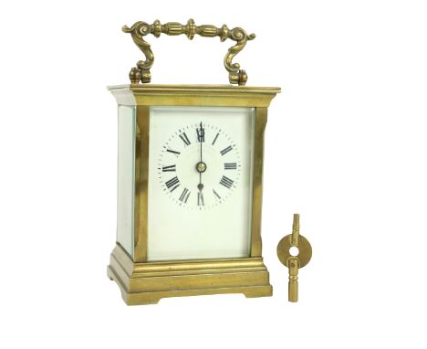 A heavy brass five glass French Carriage Clock,&nbsp;the white dial with Roman numerals and with swing handle, 5 1/2" (14cms)