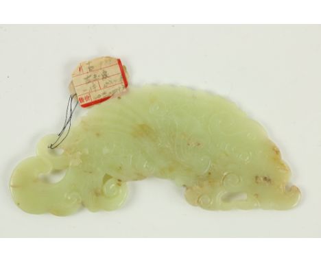 A Chinese carved jade Pendant, modelled as stylized mythical sea creature, 6" (15cms). (1) 