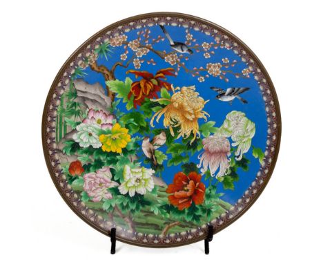 A massive Japanese cloisonne enamel Charger, profusely decorated with birds and colourful flowers, 25" (64cms). (1) 