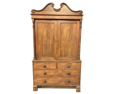 A fine Regency period mahogany Linen Cupboard on Chest, with bead moulded swan neck pediment above two nicely figured panel d