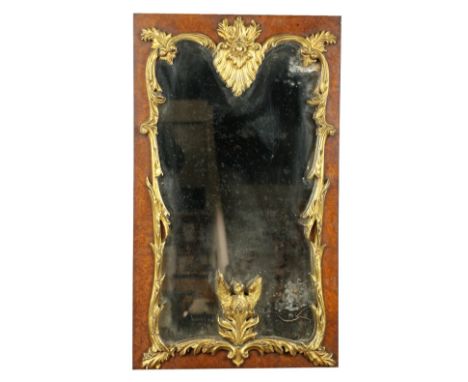 A parcel gilt and birds-eye-maple Wall Mirror, crested with a stylized leaf cartouche issuing leaf sprays and a carved Phoeni
