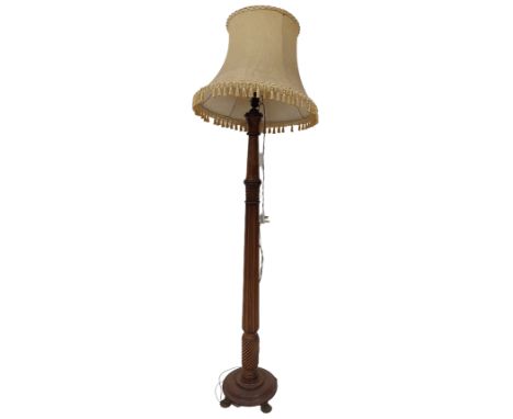 A walnut Standard Lamp, with reeded and spiral reeded stem with gold shade. (1) 