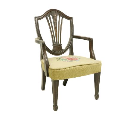 A 19th Century Hepplewhite style Child's mahogany Armchair, the shield shaped back crested with three wheat sheaves and flute