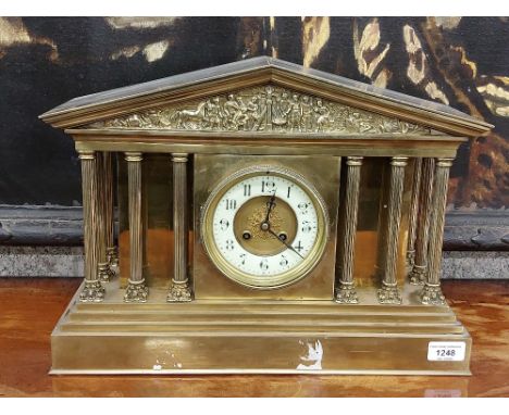 An attractive brass Temple style Mantle Clock, the arched top with decorated frieze over a circular dial with column supports