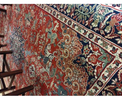 An attractive antique style Middle Eastern Carpet, the large central panel depicting figures in typical attire and on horseba