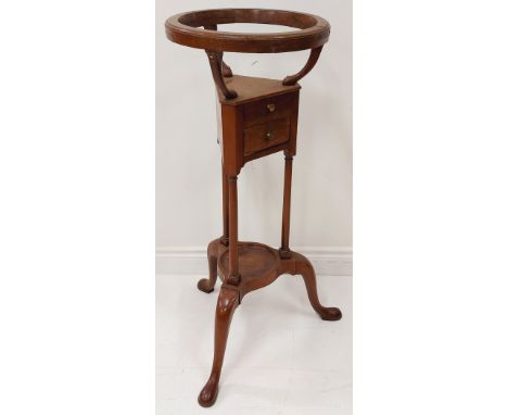 A 19th Century mahogany Washstand, with circular basin cradle, above two small drawers supported by three turned stems on a t