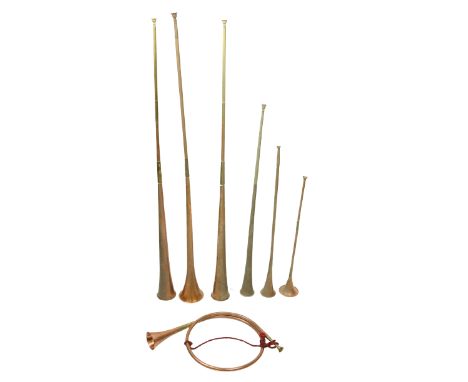 A good brass mounted French Hunting Horn, another long copper Hunting Horn by Army &amp; Navy, and five others of various siz