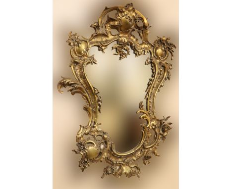 A Louis XVI style shield shaped brass Mirror, of rococo design with floral bouquet and plate mirror. (1)
