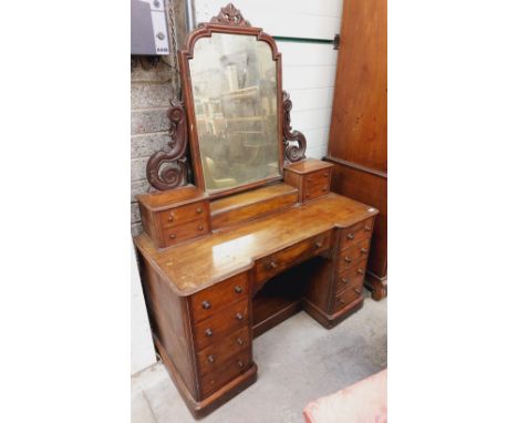 A Victorian mahogany mirrored back Ladies Dressing Table,&nbsp; the top with swing mirror carved supports, the base with cent