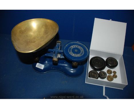 A blue traditional cast iron Victor Kitchen Scales and a complete set of weights.