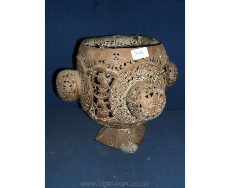 A pierced Brass Candle Lamp having four bulbous bosses to the sides and a pyramid shaped foot, 13'' diameter x 11 3/4'' high,