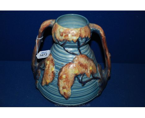 A colourful two-handled Carltonware Vase, 1163. Made in England, in ''Autumn trees'' design, 8 1/4" tall.
