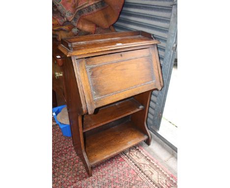 A circa 1910 Oak Student's Bureau having gallery top, the cleated fall opening to reveal five pigeon holes over lower recesse