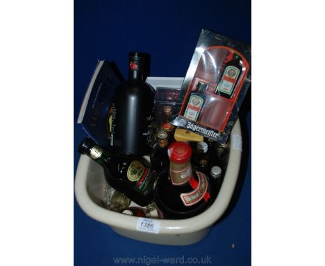 A litre bottle of Drambuie, a bottle of Glenfiddich Whisky, 70 c. bottle of Merlyn Welsh cream Liqueur, 35 cl. bottle of ''Bu