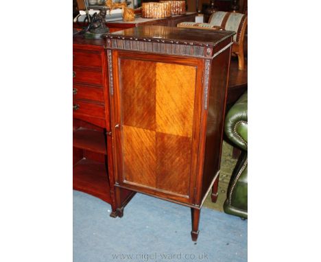 An Edwardian Mahogany Cabinet, having moulded edge rectangular top over reeded frieze, over single panel 1/4 veneered door op