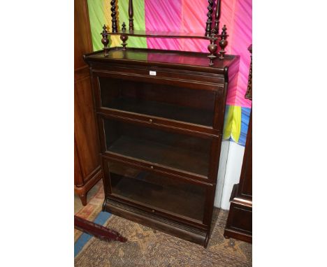 A 1930's Globe Wernicke style three tier glazed Bookcase, shaped top, the three up and over doors having single panes each, o