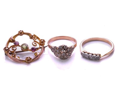 An openwork diamond cluster ring; a five stone half hoop diamond ring and an Edwardian peridot and pink tourmaline brooch. 8.