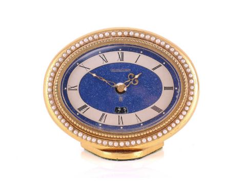 A Jaeger LeCoultre Recital 8-Day Alarm clock, with a hand-wound swiss movement in a brass oval case measuring 9cm wide with a