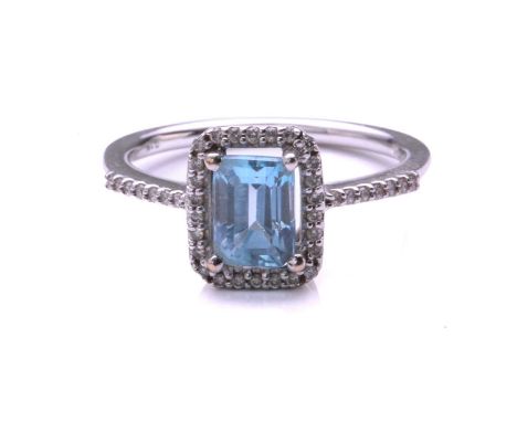 An aquamarine and diamond cluster ring; the cut-cornered rectangular step cut aquamarine, in claw mounts above a border of ci