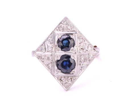 A Sapphire and Diamond set panel ring, comprising two Sapphires set opposingly on a white metal pane stamped 'Plat' with 8-cu