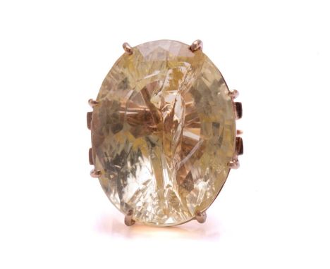 A large citrine ring, featuring an oval mixed-cut citrine in a pale yellow colour, with a prominent incipient fracture, gemst