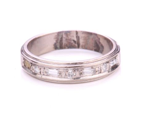 A diamond half eternity ring, alternatively pavé-set with baguette diamonds and round diamonds, to ring band with a ridged ed