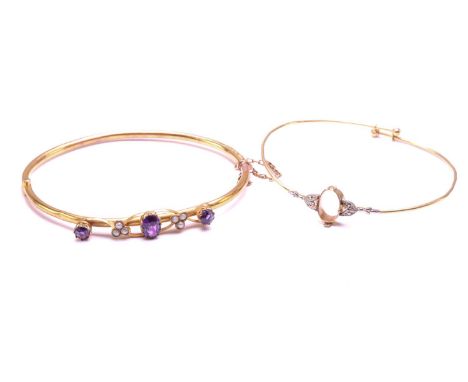 An Edwardian amethyst and seed pearl bangle and another; the 9ct gold hinged bangle comprises three faceted amethyst, flanked