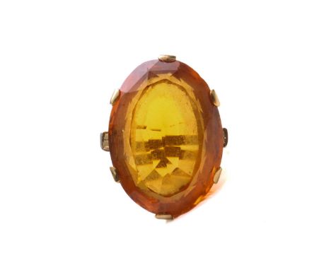 A large citrine dress ring in 18ct yellow gold, featuring an oval-shaped mixed-cut citrine with deep orange colour, approxima