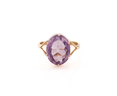 An amethyst ring, consisting of an oval-cut amethyst approximately measures 14.5 x 11.2 mm, claw collet set in mount with bif